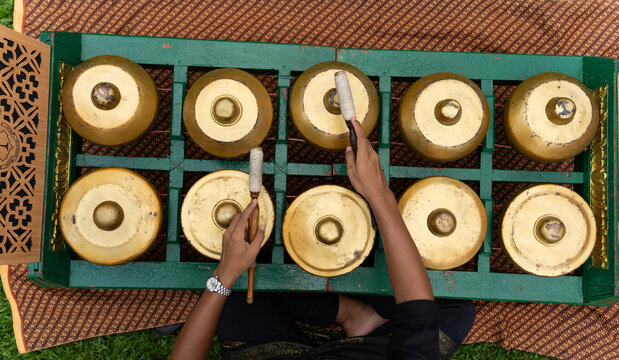 Musician Playing Traditional Gamelan Bonang Instrument