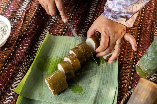 Woman Slicing Traditional Malay Lemang Glutinous Rice