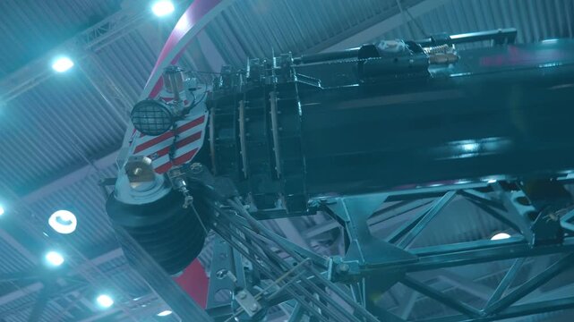 The telescopic boom of the new truck crane with a large hook is presented at the exhibition. Closeup. Shot in motion