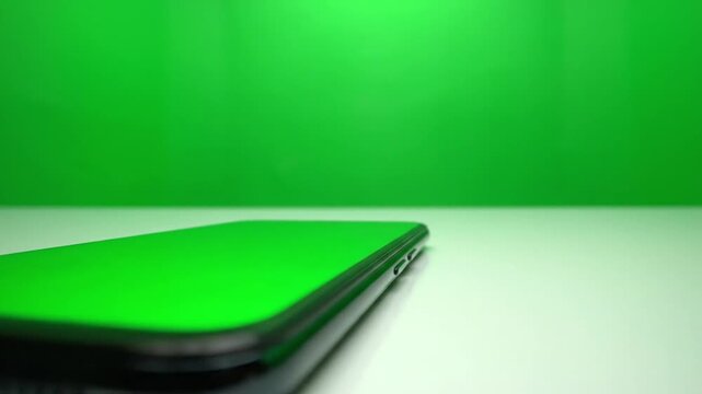 Smartphone Mockup with Green Screen Display on White Table - Close Up Chroma Key Mobile Phone Footage - Tech Device Presentation and App Template Video