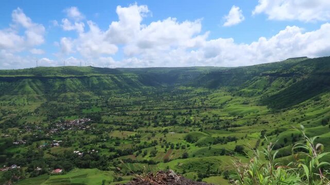 Beautiful timelapse from Sajjangad Fort with green mountains, villages, and moving clouds.