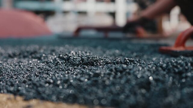 Leveling rubber crumb surface during coating installation close up
