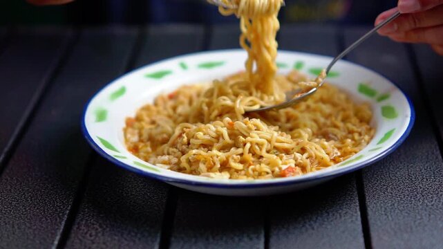 Mie nyemek. An Indonesian noodle dish cooked with a little water, beaten egg, and thick sauce.