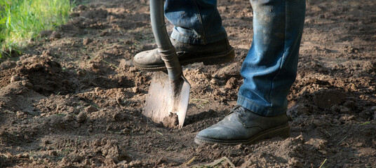 Man's feet with a shovel © Marina