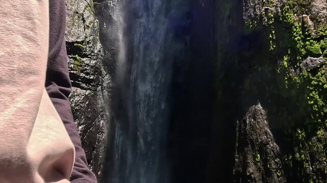 Asian woman vacation at Dolo waterfall. One of beautiful waterfall in East Java, Indonesia.