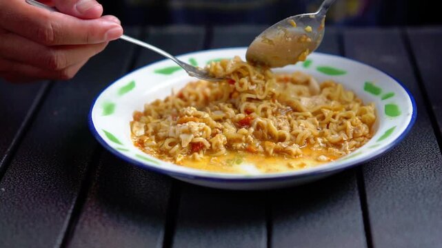 Mie nyemek. An Indonesian noodle dish cooked with a little water, beaten egg, and thick sauce.