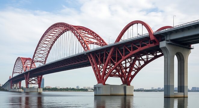 Elegant red arch bridge spanning a calm body of water under a cloudy sky