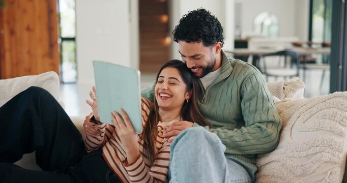 Tablet, relax and couple on sofa in home with laugh for funny meme on social media, texting or website. Happy, digital technology and man with woman in living room for humor with online joke in house