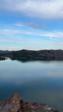 Panoramic view of the La Tranquera Reservoir with its tranquil waters surrounded by mountains and rock formations. Natural landscape with reflections in the water and an incredible sky. Zaragoza,Spain