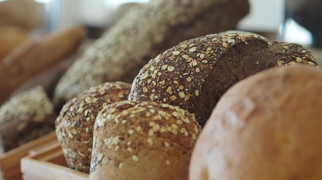 Fresh bread rolls and loaves on display in bakery shop