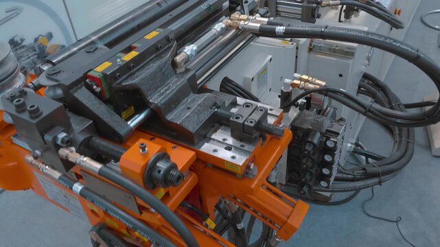 A modern, high-tech pipe bending machine is presented at the exhibition. Closeup. Shot in motion
