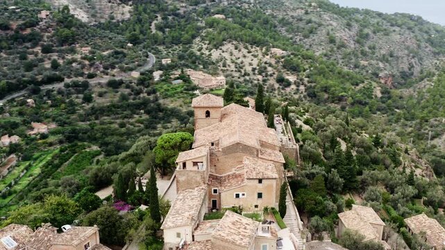 Aerial view of Valldemossa village landmark on Mallorca island in Spain. Cathedral architecture in mountains, beautiful nature landscapes, urban tourist points of Europe.