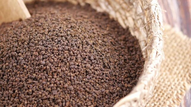 Close-up of Dry Black CTC Tea Leaves in a Woven Basket