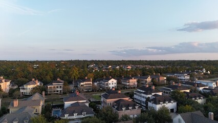 Aerial view of luxury houses in Houston, Woodlands by the lake with dramatic cloudy sky in Texas,...