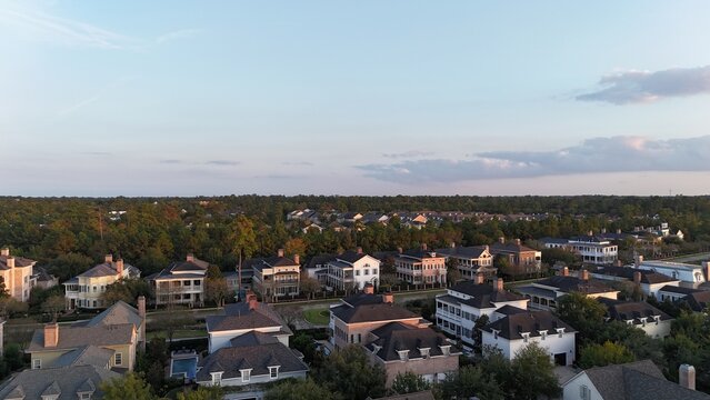 Aerial view of luxury houses in Houston, Woodlands by the lake with dramatic cloudy sky in Texas, United States