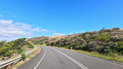 Obraz premium Winding Asphalt Road Along the Great Ocean Road in Victoria Australia