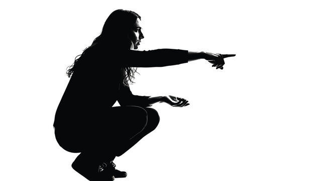 Silhouette of a long haired person crouching down and pointing their finger forward in a dramatic studio photo captured with high contrast lighting to emphasize the expressive pose and gesture