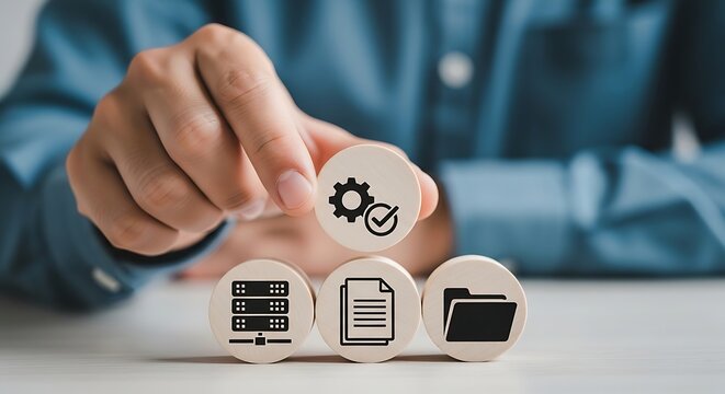 Person holding gear above server document and folder on white table hand blue shirt checkmark