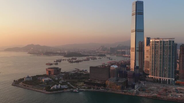 Hong kong icc skyscraper and victoria harbour at sunset