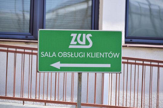 ZUS (Social Insurance Institution, Polish name: Zaklad Ubezpieczen Spolecznych). Sign with logo, emblem and direction to customer service room. WARSAW, POLAND - APRIL 28, 2026