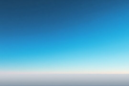 Serene clear blue sky at twilight over a calm horizon