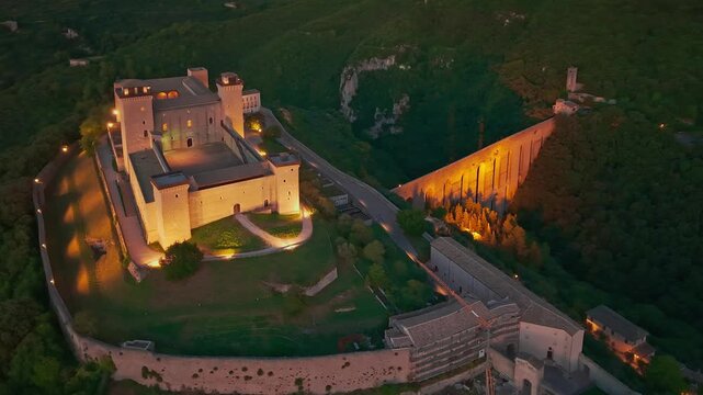 Aerial view of Spoleto at night with Ponte delle Torri and Fortress