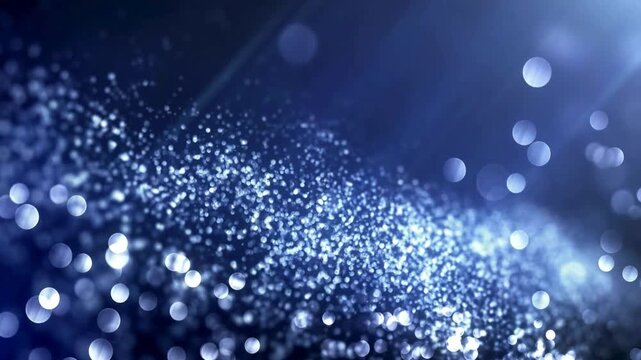 Dark blue abstract background with shimmering light particles moving dynamically in waves and glowing bokeh effects, cinematic motion footage.