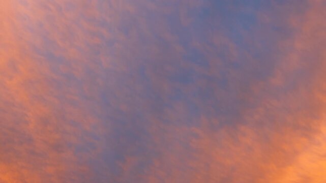 Warm twilight clouds moving through a colorful and dramatic sunset sky