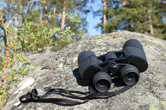Black binoculars on cliff. Bird watching concept. J&auml;rf&auml;lla, Stockholm, Sweden.