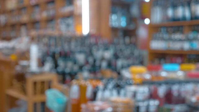 Bottled wine and juice, jam in jars, dried fruits and big variety of local and imported liquors are beautifully placed on the wooden shelves in the store in Da Lat, Vietnam