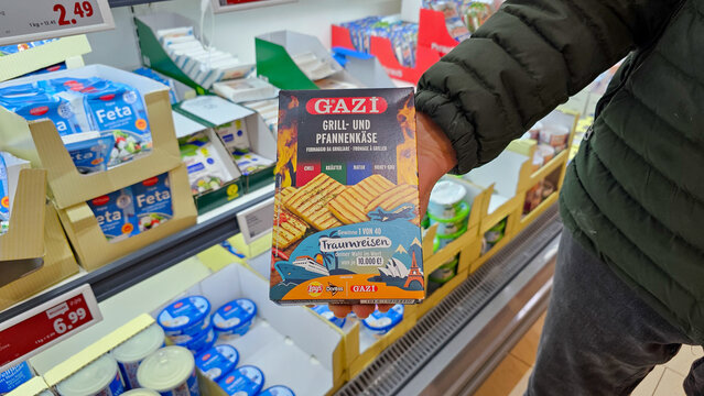 Customer holding gazi grill and pan cheese in supermarket
