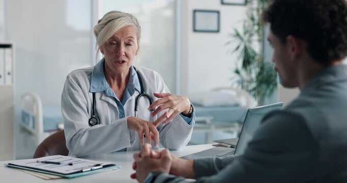 Healthcare, doctor or discussion with man in clinic for medical results, treatment options or help. Checkup, mature professional or consulting patient for health feedback, diagnosis or follow up care