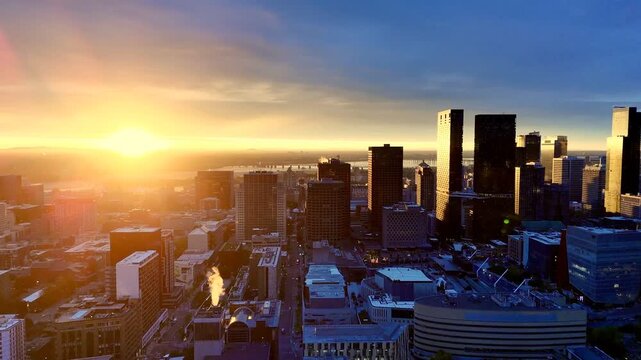 Vibrant sunrise over Montreal skyline with St Lawrence River and La Grande Roue reflecting colorful evening sky. g.