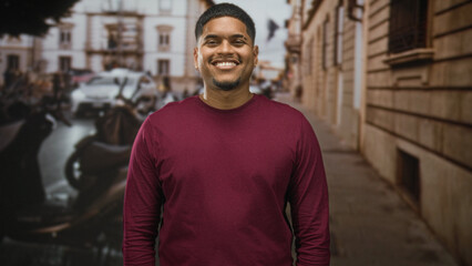 Fototapeta premium Hispanic man with beard standing facing camera, eyes closed then smiling across frames, wearing maroon shirt on a street; serenity presence.
