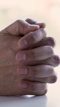 Close up of hands of nervous, anxious and worried man fidget with finger feeling stress, uncertain and overwhelmed while waiting for job interview. Fingers of worker with adhd feeling unsure, scared.