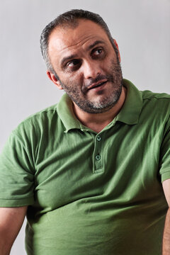 Thoughtful Middle Eastern Man with a beard Looking Directly At the Camera