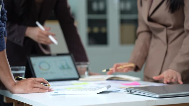 Business consultants discuss tax, merger strategy and restructuring in modern office.