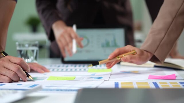 Businessmen team or financial data analysts working with tablets and laptop computers and data graphs together. Plan to analyzing projects in the office.