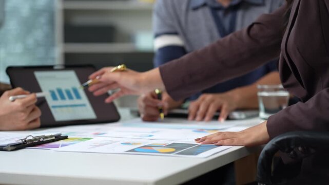 Businessmen team or financial data analysts working with tablets and laptop computers and data graphs together. Plan to analyzing projects in the office.