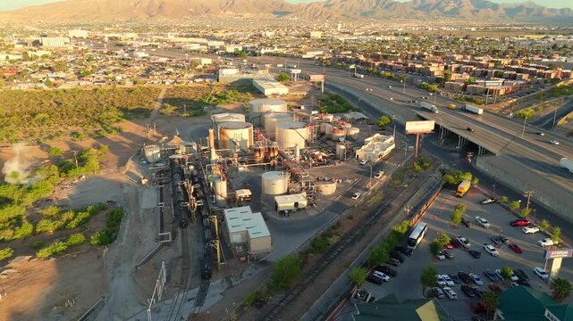El Paso industrial corridor with refinery tanks roads and desert mountains