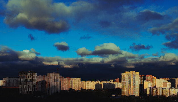 A landscape view of a large residential area at sunset with an incredible sky