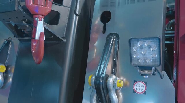 A truck towing anchor and hook on a new truck crane on display at the exhibition. Closeup. Shot in motion