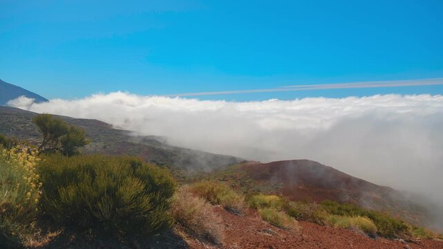 Panning timelapse above sea of clouds on volcanic slope, Mount Teide in background, Tenerife, Canary Islands 4K