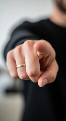 Obraz premium Close-up of a Hand Pointing Directly at the Viewer with a Ring.