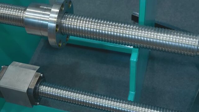 Samples of new trapezoidal shafts for precise and stable movement of carriages of modern machine tools and other tasks are presented at the exhibition. Closeup. Shot in motion