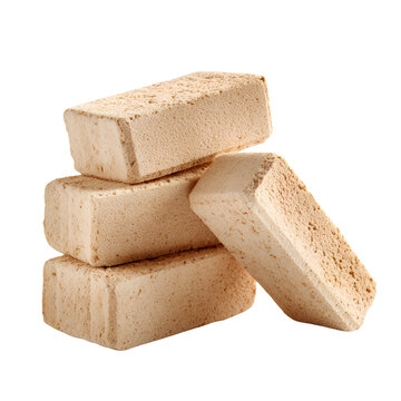 Stacked beige construction bricks isolated on white background