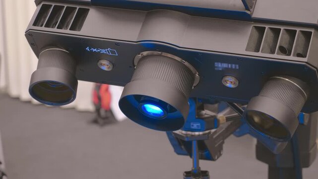 An industrial 3D scanner captures data from a part rotated on specialized equipment. Closeup. Shot in motion