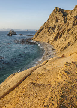Paracas, Peru - 3 Dec 2025: Sunset on the Pacific coast in the deserts of the Paracas National Reserve, Peru