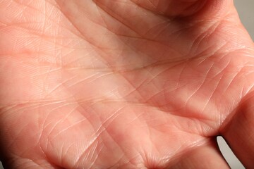 Fototapeta premium Human hand with normal skin on light background, closeup