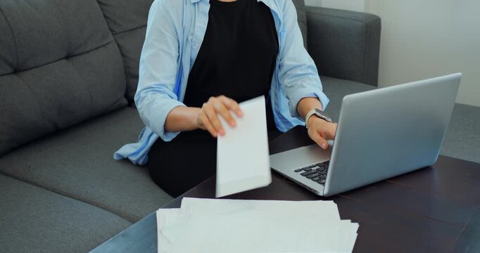 Hands organize papers. Sorting papers and organizing envelope at work station for scanning. Hands meticulously arrange documents and prepare envelope for digital storage process before scanning